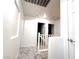 Upstairs hallway featuring stylish tile flooring, white walls, and multiple doors at 3311 Fico Ave, Las Vegas, NV 89141