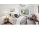 Cozy bedroom with a ceiling fan, large window with backyard views, and calm interior design at 3425 E Russell Rd # 202, Las Vegas, NV 89120