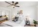 Inviting bedroom featuring mirrored closet, calming decor, ceiling fan, and hardwood floors at 3425 E Russell Rd # 202, Las Vegas, NV 89120