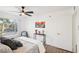 Comfortable bedroom with view, featuring ceiling fan, light walls, and minimalist decor at 3425 E Russell Rd # 202, Las Vegas, NV 89120
