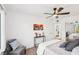 Stylish bedroom featuring ceiling fan, calming decor, backyard view, and hardwood floors at 3425 E Russell Rd # 202, Las Vegas, NV 89120