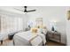 Inviting main bedroom with ceiling fan, two nightstands, and large window for natural light at 3425 E Russell Rd # 202, Las Vegas, NV 89120