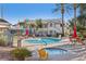 Community pool and jacuzzi area surrounded by lush landscaping and seating at 3425 E Russell Rd # 202, Las Vegas, NV 89120