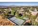 Expansive aerial view of a private estate featuring a tennis court, pool, and mature landscaping at 3455 Five Pennies Ln, Las Vegas, NV 89120