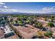 Large lot featuring green trees, sheds, and a potential home site against a backdrop of blue sky at 3455 Five Pennies Ln, Las Vegas, NV 89120