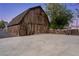 Exterior of the large barn with adjacent parking area and rustic style at 3455 Five Pennies Ln, Las Vegas, NV 89120