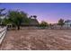 Rustic barn with fenced enclosure under a twilight sky, showcasing the property's charm at 3455 Five Pennies Ln, Las Vegas, NV 89120