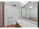 Bathroom with tile countertops, single sink, and large mirror at 3455 Five Pennies Ln, Las Vegas, NV 89120