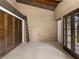 Bedroom with exposed beam ceiling, brick walls, double door closet, and French doors to backyard at 3455 Five Pennies Ln, Las Vegas, NV 89120