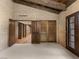 Bedroom with brick walls, beamed ceiling, and doors to outside at 3455 Five Pennies Ln, Las Vegas, NV 89120