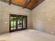Bedroom features brick walls, beamed ceiling, and doors to outside at 3455 Five Pennies Ln, Las Vegas, NV 89120