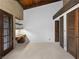 Spacious bedroom with exposed beam ceiling, brick walls, built-in desk and access to closet at 3455 Five Pennies Ln, Las Vegas, NV 89120