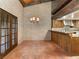 Bright dining area with tiled floors, brick walls, wood beams, and a pass-through to the kitchen at 3455 Five Pennies Ln, Las Vegas, NV 89120