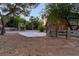 Exterior view of the property with a basketball court and large barn at 3455 Five Pennies Ln, Las Vegas, NV 89120