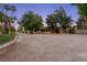 Home exterior featuring mature trees and landscaping at 3455 Five Pennies Ln, Las Vegas, NV 89120