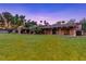 A sprawling single-story home with a red tile roof and a spacious, well-manicured lawn at 3455 Five Pennies Ln, Las Vegas, NV 89120