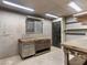Well-lit garage interior with storage and workspaces at 3455 Five Pennies Ln, Las Vegas, NV 89120