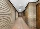 Hallway with brick walls, tile floor and built in cabinets at 3455 Five Pennies Ln, Las Vegas, NV 89120