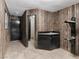 A room with wood paneled walls, a sink, saddle holders, and access to a bathroom at 3455 Five Pennies Ln, Las Vegas, NV 89120