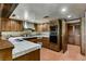 Traditional kitchen with wood cabinets, a built-in oven, and tiled countertops at 3455 Five Pennies Ln, Las Vegas, NV 89120