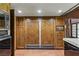 Bright kitchen with wood paneled appliances, cabinets and terracotta tiled floors at 3455 Five Pennies Ln, Las Vegas, NV 89120