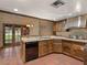 Well-lit kitchen featuring classic cabinetry, a tile backsplash, and outdoor access at 3455 Five Pennies Ln, Las Vegas, NV 89120