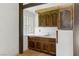 Charming kitchenette with wooden cabinets, vintage sink, and tiled countertops at 3455 Five Pennies Ln, Las Vegas, NV 89120