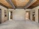 Bright and spacious living room showcasing brick walls, carpeted floors and wood beam ceilings at 3455 Five Pennies Ln, Las Vegas, NV 89120