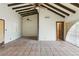 Open living room layout with beamed ceilings, tile flooring, and natural light at 3455 Five Pennies Ln, Las Vegas, NV 89120