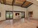 Large living room featuring brick walls, a fireplace, and french doors to the outside at 3455 Five Pennies Ln, Las Vegas, NV 89120