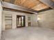 Large, cozy living room featuring brick walls, exposed wood beams, and plush carpeting at 3455 Five Pennies Ln, Las Vegas, NV 89120