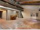Expansive room with exposed beam ceiling, brick walls, and terracotta floors at 3455 Five Pennies Ln, Las Vegas, NV 89120