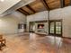 Spacious living room with a rustic brick fireplace and wood-beamed ceiling at 3455 Five Pennies Ln, Las Vegas, NV 89120