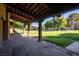 Spacious covered patio featuring brick walls, wooden beams, and view of backyard at 3455 Five Pennies Ln, Las Vegas, NV 89120