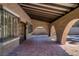 Covered outdoor patio featuring a brick-lined ceiling, arched walkways, and decorative iron accents at 3455 Five Pennies Ln, Las Vegas, NV 89120