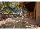 Covered patio featuring brick walls, wooden beams, and view of trees at 3455 Five Pennies Ln, Las Vegas, NV 89120