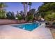 Backyard swimming pool with mature trees and landscaping in a private, gated community at 3455 Five Pennies Ln, Las Vegas, NV 89120