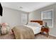 Cozy bedroom with warm carpet, window, and inviting bed at 3514 Punta Tersiva Ln, Henderson, NV 89044