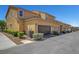 Townhouse exteriors featuring garages, desert landscaping, and a well-maintained street at 3514 Punta Tersiva Ln, Henderson, NV 89044