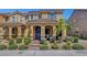 Charming two-story home with a blue front door, landscaped yard, and inviting curb appeal at 3514 Punta Tersiva Ln, Henderson, NV 89044