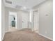 Upstairs hallway with neutral carpet and multiple doors leading to other rooms at 3514 Punta Tersiva Ln, Henderson, NV 89044