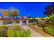 Professionally landscaped entrance to the neighborhood at dusk at 3514 Punta Tersiva Ln, Henderson, NV 89044