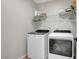 Functional laundry room equipped with appliances and storage shelving at 3514 Punta Tersiva Ln, Henderson, NV 89044