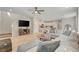 Bright, open living space with a large sectional sofa, ceiling fan, and seamless flow to the kitchen at 3514 Punta Tersiva Ln, Henderson, NV 89044