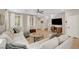 Open-concept living area with hardwood flooring, a large sectional, and a view of the staircase at 3514 Punta Tersiva Ln, Henderson, NV 89044