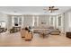 Spacious living room featuring a large sectional sofa, hardwood floors, and ample natural light at 3514 Punta Tersiva Ln, Henderson, NV 89044