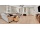 Light-filled living room with hardwood floors, a comfortable sectional sofa, and stylish furnishings at 3514 Punta Tersiva Ln, Henderson, NV 89044