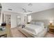 Spacious bedroom with neutral tones, a ceiling fan, and two windows for natural light at 3514 Punta Tersiva Ln, Henderson, NV 89044