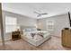 Spacious bedroom with neutral tones, a ceiling fan, and natural light from two windows at 3514 Punta Tersiva Ln, Henderson, NV 89044