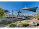 Community playground with covered swings and climbing structures at 3514 Punta Tersiva Ln, Henderson, NV 89044